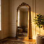 A finished period living room with the gold arched mirror