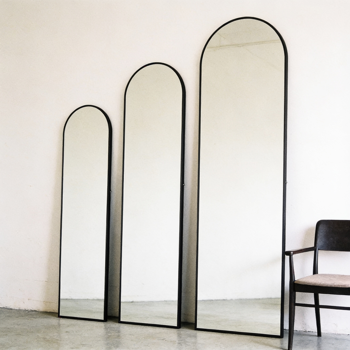 The three sizes side by side with a chair for scale