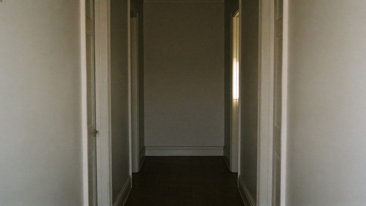 Same corridor with a bare unresolved end wall